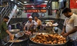 A chef prepares fried chicken and fish for the customers in Old Delhi, India, on 20 July 2...