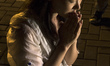 Kelly Wen, wife of a missing passenger prays as she take part in an event for the missing...