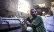 A worker on the machine for recycling of plastic in the district of Mokattam (the garbage...