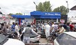 People gather at the petrol filling station in Srinagar on August 03, 2019. Government of...