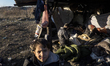 An Afghan boy traveling with his family is among the migrants camping  under a makeshift...