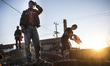 Afghan migrants using well water to wash and do laundry at  "The Jungle," an abandoned bri...