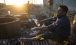 An Afghan man washes his feed before prayer at "The Jungle" a migrant camp near the Serbia...