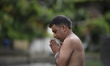 A Nepalese devotee offering ritual prayer during Janai Purnima festival or Rakchhya Bandha...