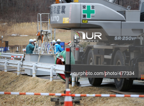 (150310) -- FUKUSHIMA, March 10, 2015 () -- Workers are seen behind large equipment in the town of Iitate, Fukushima Prefecture, Japan, Marc...