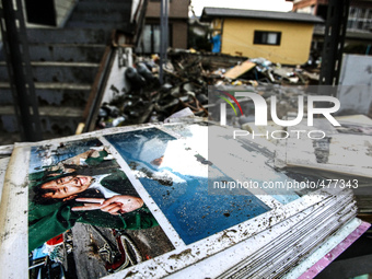 A family album outsite a collapsed house  in the devastated city of Ishinomaki on April 15, 2011 following the deadly March 11 earthquake an...