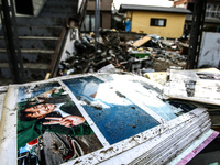 A family album outsite a collapsed house  in the devastated city of Ishinomaki on April 15, 2011 following the deadly March 11 earthquake an...
