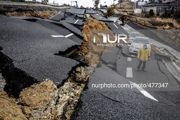 A man walks in a destroyed street in the devastated city of Ishinomaki on April 15, 2011 following the deadly March 11 earthquake and tsunam...