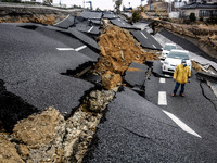 A man walks in a destroyed street in the devastated city of Ishinomaki on April 15, 2011 following the deadly March 11 earthquake and tsunam...