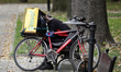 A Glovo delivery courier is seen resting in a park on August 7, 2019 in Warsaw, Poland. 