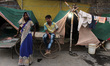 People settle in camps provided by Delhi govt near the Old Yamuna Bridge as water level ha...