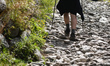 A tourist walks on a rocky trail direction Kasprowy Wierch.Thanks to the sunny weather at...
