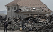 FILE - In this file photo, taken on April 13, 2011, women walk in a destroyed area of  Sen...