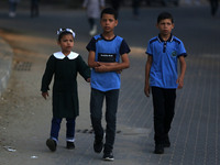 Palestinian students walk on their way at a United Nations-run school, on the first day of a new school year, in Gaza City on August 25, 201...