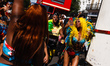 Paraders dance on Chepstow Road on the opening day of the 2019 Notting Hill Carnival in Lo...