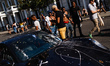 Revellers stop to look at a paint-covered Porsche on Arundel Gardens on the second and fin...