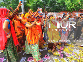 Family members and supporters of the candidates dance during the Rajasthan University Students Union (RUSU) election polling, outside Mahara...