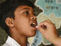 School student recieves Albendazole tablet as part of India's National Deworming Programme at a primary school in Guwahati, Assam, India on...