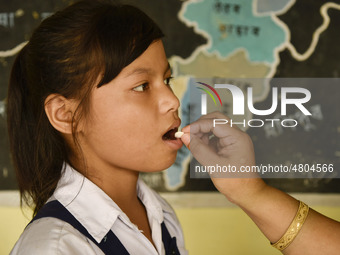 School student recieves Albendazole tablet as part of India's National Deworming Programme at a primary school in Guwahati, Assam, India on...