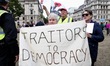 Anti-Brexit demonstrators, secured by a number of police officers, protest at Parlament Sq...