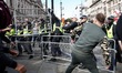 Pro-Brexit demonstrators throw a metal barrier at policemen during clashed with polce forc...