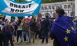 Pro and Anti-Brexit demonstrators, secured by a number of police officers, protest at Parl...