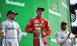 Winner Ferrari's Monegasque driver Charles Leclerc (C) celebrates next to second placed Me...