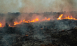 An Indonesian firefighter tries to extinguish peatland fire at Tanah Merah Village, Kampar...