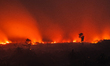 An Indonesian firefighter tries to extinguish peatland fire at Tanah Merah Village, Kampar...
