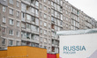 Russia inscription on the transformer building in front of soviet era block of flats is se...