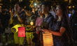 People are seen holding up lanterns in Victoria Park in Hong Kong on September 13, 2019, H...
