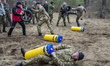 Volunteers and reserve soldiers are carrying punching bag imitating rescuing wounded colle...
