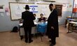BNEI-BRAK, ISRAEL - MARCH 17, 2015: An Ultra-Orthodox jewish man posts his vote in a polli...