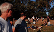 People relax in warm early evening sunshine in Kensington Gardens in London, England, on S...