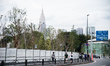 People are seen walking past the building of the Olympic Stadium of Tokyo, who will host t...