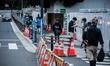 A worker is seen walking past the building of the Olympic Stadium of Tokyo, who will host...