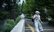 A worker is seen walking past the building of the Olympic Stadium of Tokyo, who will host...