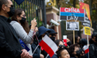 Demonstrators holding placards are seen during a rally against Chinese government  on Sept...