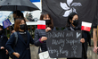 Demonstrators holding placards are seen during a rally against Chinese government  on Sept...