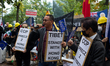 Demonstrators holding placards are seen during a rally against Chinese government  on Sept...