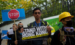 Demonstrators holding placards are seen during a rally against Chinese government  on Sept...