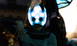 Portrait of an environmental activist wearing a luminous mask made of LEDs facing a Rebell...
