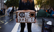 A member of climate change activist group Extinction Rebellion (XR) stands with a placard...