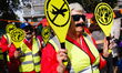 Members of climate change activist movement Extinction Rebellion (XR) dressed as air traff...