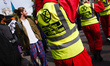 Members of climate change activist movement Extinction Rebellion (XR) dressed as air traff...