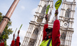 Members of climate change activist movement Extinction Rebellion (XR) dressed as air traff...