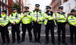 Police officers stretch across Great Peter Street, near the Home Office where members of c...