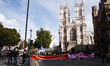 Banners stretch across Victoria Street outside Westminster Abbey as members of climate cha...