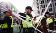 Police officers clear tents belonging to members of climate change activist movement Extin...