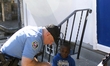 Police officers interact with youth from the community during a block party on Sunday Octo...